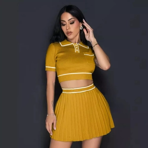 Women's yellow knit two-piece set featuring short-sleeve polo top and pleated mini skirt