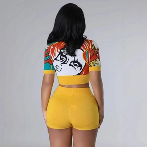Bright yellow two-piece knit set with colorful pop art portrait on short sleeve crop top
