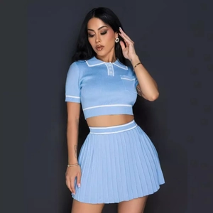 Light blue knit two-piece set featuring short sleeve crop top and pleated mini skirt