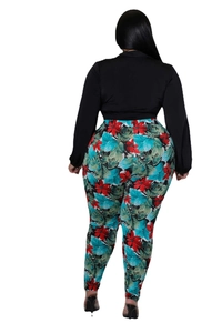 Rear view detail of high-waist tropical print leggings with a black long-sleeve crop top