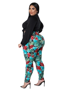 Detail of high-waist leggings with tropical floral print and black tie-up crop top