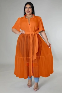Macro detail of sheer orange chiffon mesh fabric and layered hem on a plus size maxi dress