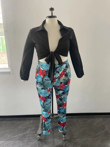 Detail of two-piece set with black tie-front top and blue floral leggings on mannequin
