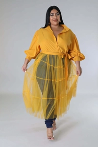 Detail of plus size yellow puff sleeve top with tiered mesh overlay and waist tie