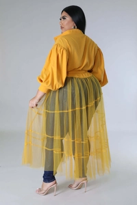 Detail of plus size mustard yellow shirt with lantern sleeves and sheer mesh skirt overlay