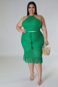 Close-up of green crochet knit skirt featuring drawstring waist and fringe details