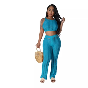 Women's teal knit two-piece set with sleeveless crop top and high waist wide leg pants