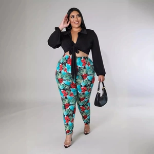 Women's plus size two-piece set featuring black tie-front top and floral print trousers