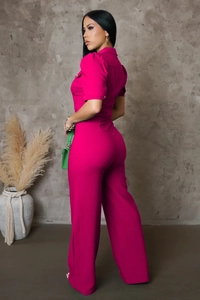 Detailed view of hot pink wide-leg jumpsuit with short sleeves and buttoned collar