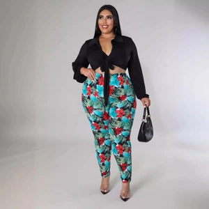 Women's plus size two-piece set featuring black tie-front shirt and tropical floral pants