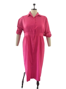 Detail view of the elastic waist and button-up front of this solid rose red shirt dress