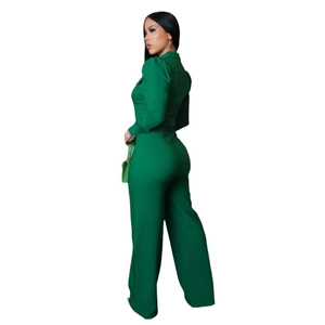 Detail of the high waist and back silhouette of a deep green long sleeve jumpsuit