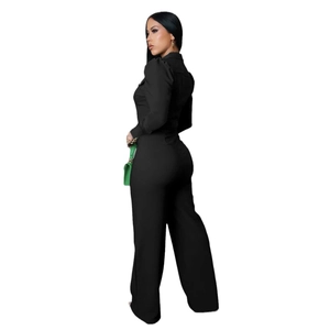 Detail of elegant black long sleeve jumpsuit featuring lapel collar and wide-leg trousers