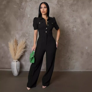 Short sleeve bodycon jumpsuit with bubble sleeves and gold buttons on industrial background