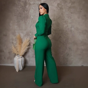 Chic emerald green long sleeve wide leg jumpsuit with fitted waist and side pockets