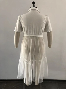 Detail of plus size white dress featuring short sleeves and long translucent mesh hemline