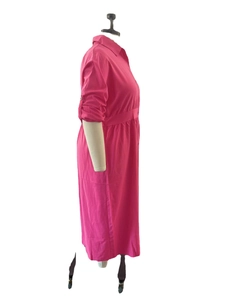Side view of rose red long sleeve shirt dress with waist pleats on white mannequin