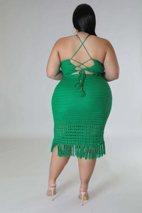 Macro detail of green crochet knit dress featuring lace-up back and fringed tassels