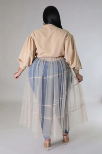 Detail view of khaki puff sleeve top with layered sheer mesh dress in a plus size outfit