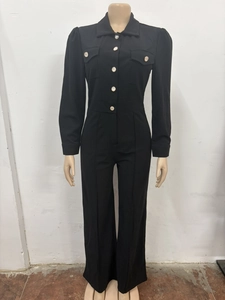 Close-up of contrast white buttons and lapel collar on black long sleeve jumpsuit