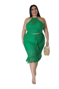 Detail of green crochet two-piece set featuring hollow knit texture and long tassel hem