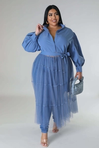 Detail of plus size blue dress featuring puff sleeves and layered mesh pleated skirt