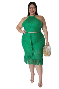 Detail of green crochet two-piece set featuring tassel fringe and halter knit texture
