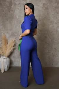 Rear side view of electric blue jumpsuit featuring short sleeves and wide-leg design