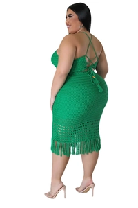 Detail of green knit plus size dress featuring back criss-cross straps and fringe hem