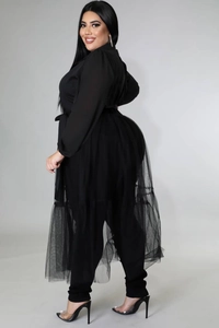 Detail of plus size black outfit with layered sheer mesh skirt and chiffon ruffles