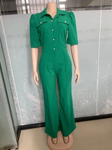 Detail showing pearl texture buttons and front pockets on the green utility jumpsuit