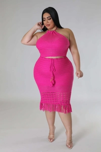 Detail of rose pink crochet knit two-piece set with halter neck top and fringe hem skirt