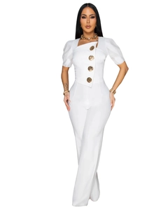 Detail of white short sleeve jumpsuit featuring decorative large gold buttons and slim fit waist