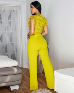 Detailed back view of sleeveless lace patchwork athletic jumpsuit in bright yellow