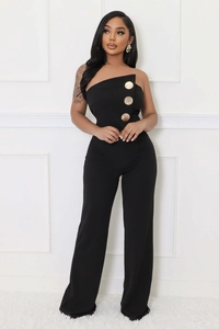 Close-up of black strapless jumpsuit featuring three large decorative gold buttons and slit