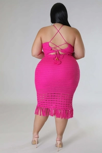 Detail of rose red crochet dress featuring criss-cross back straps and long fringe hem