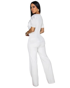 Detail view of the sleek back zipper and fitted silhouette on this white short-sleeve jumpsuit