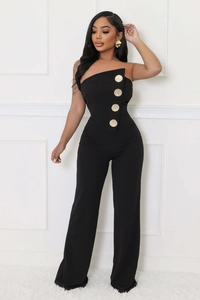 Detail of black strapless jumpsuit with decorative large gold buttons on the bodice