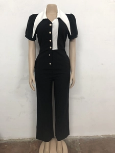 Close-up of contrast patchwork jumpsuit with white lapel collar and pearl buttons