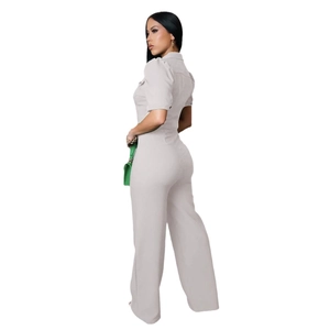Detail of light grey short sleeve jumpsuit with lapel collar and fitted waist design