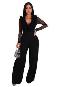 Detailed view of sheer mesh sleeves and ruffled V-neck on black mesh patchwork jumpsuit