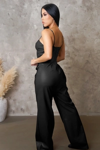 Detailed back view of black PU leather jumpsuit with thin straps and sleek zipper detail