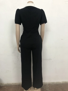 Rear view of sleek black slim fit jumpsuit with contrasting white collar and waist design
