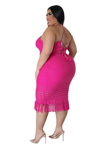 Macro detail of rose pink crochet dress featuring back criss-cross straps and long fringe hem
