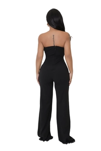 Detail view of the back of a black strapless jumpsuit featuring a seamless hidden zipper