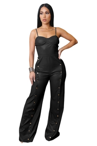 Detail of black faux leather wide-leg jumpsuit featuring decorative side metal buttons