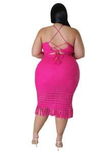 Detail view of the rose red crochet dress featuring criss-cross back straps and tassels