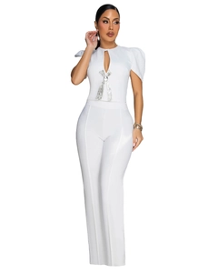 Detail of white two-piece set with silver rhinestone bow and high-waisted wide-leg trousers