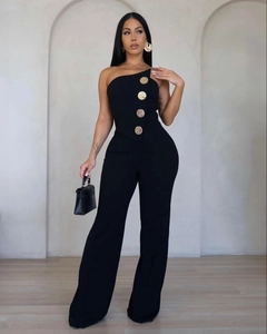 Detail of elegant gold relief buttons on the side of a sleek black strapless jumpsuit
