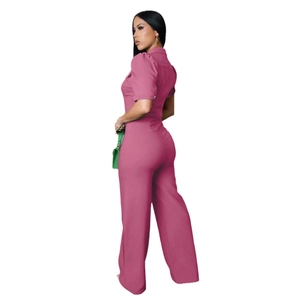 Detail view of the rose red short sleeve jumpsuit with tailored high waist and wide legs